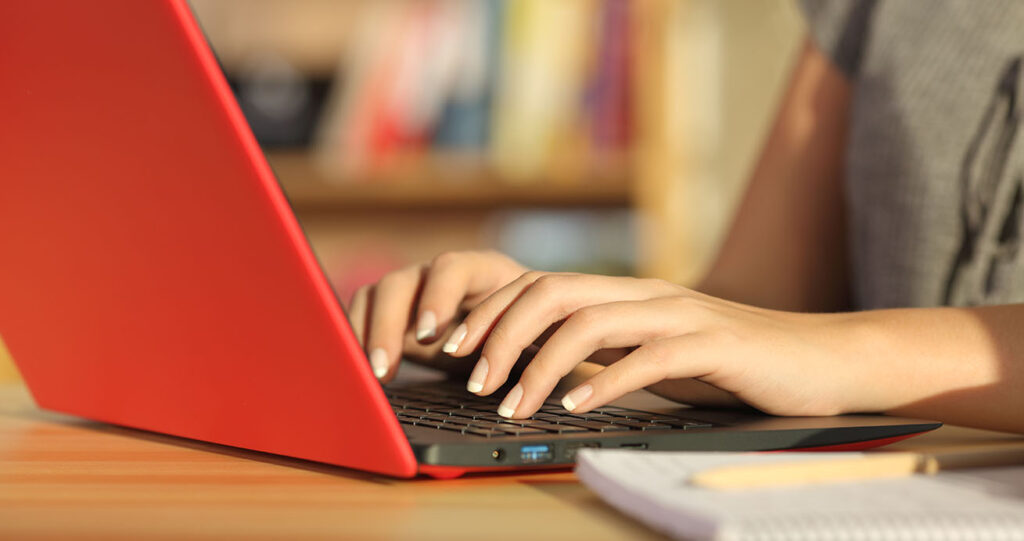 Woman typing on laptop