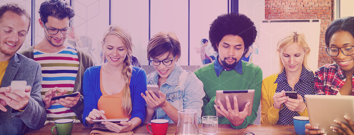 Group of students looking at mobile devices