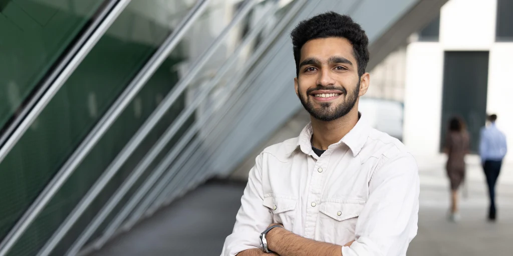 The photo shows a Work Ready Graduate Programme participant smiling.